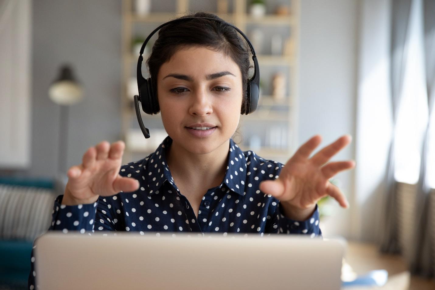 IT professional wearing headset working at her laptop