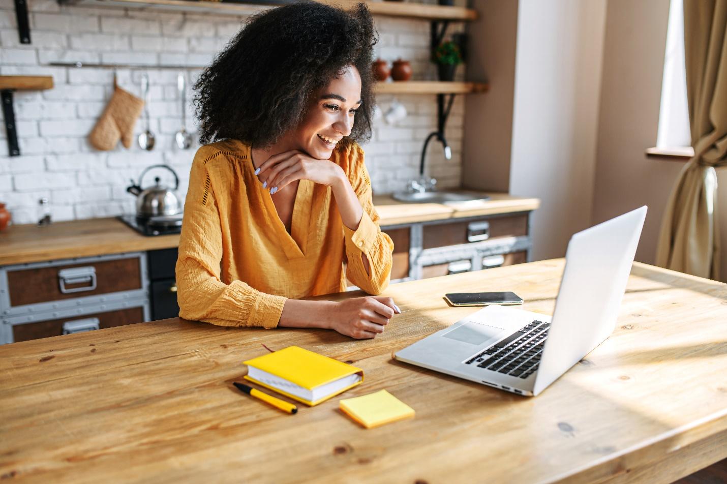 An IT professional working remotely at a laptop